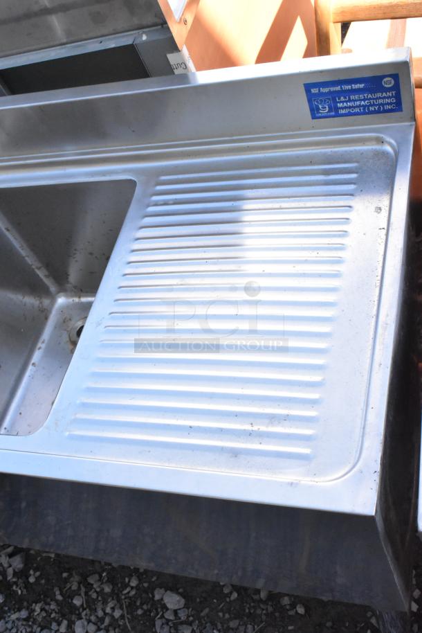 Stainless steel 3-bay back bar sink with dual side drain boards, double speedwell, and labeled faucet. NSF approved.