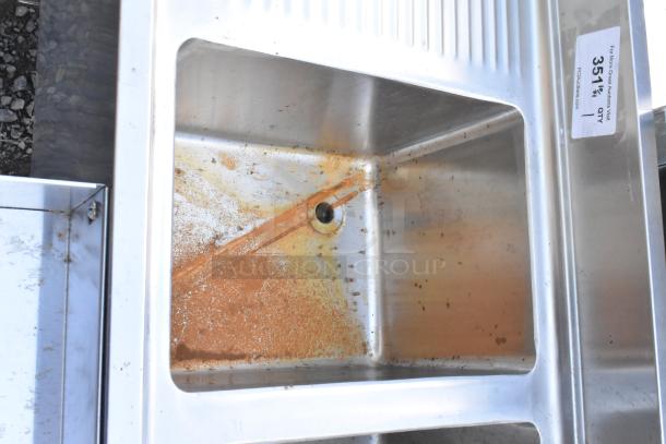 Stainless steel 3 bay back bar sink with dual side drain boards, double speedwell, and faucet; some rust visible in basin.