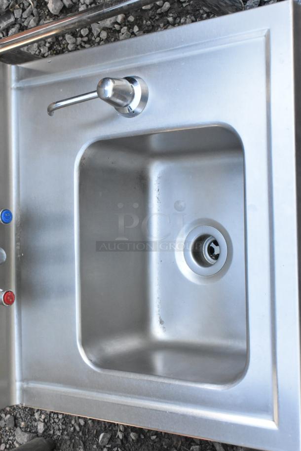 Stainless steel single bay wall mount sink with faucet, good condition, integrated faucet and drain, wall mount design.