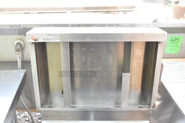 Stainless steel single bay wall mount sink with faucet, industrial design, in used condition. Features visible mounting and plumbing.
