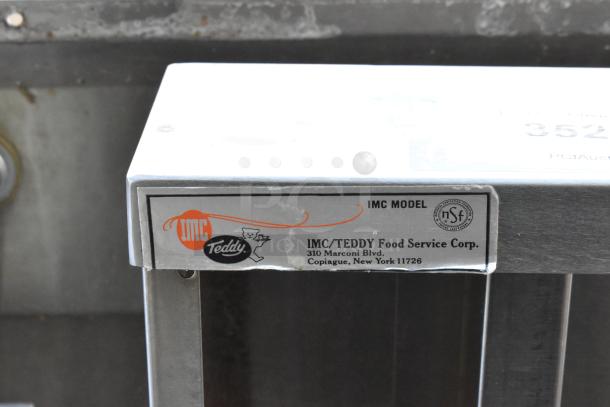 Stainless steel single bay wall mount sink with faucet, featuring IMC/Teddy label indicating NSF certification.