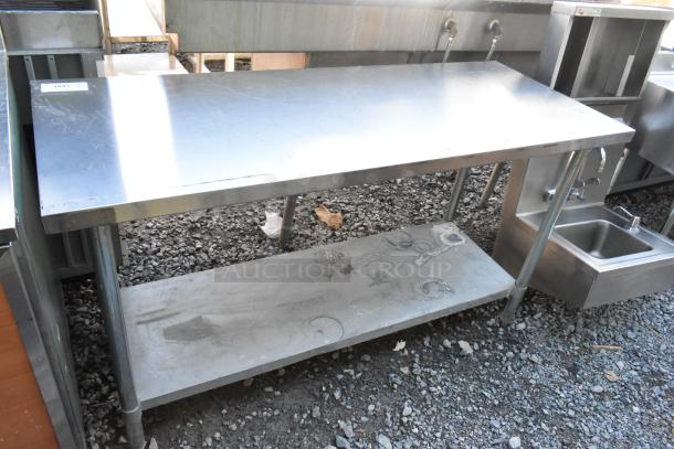 Stainless steel table with metal under shelf, used, showing minor surface scratches. Ideal for kitchen or industrial use.
