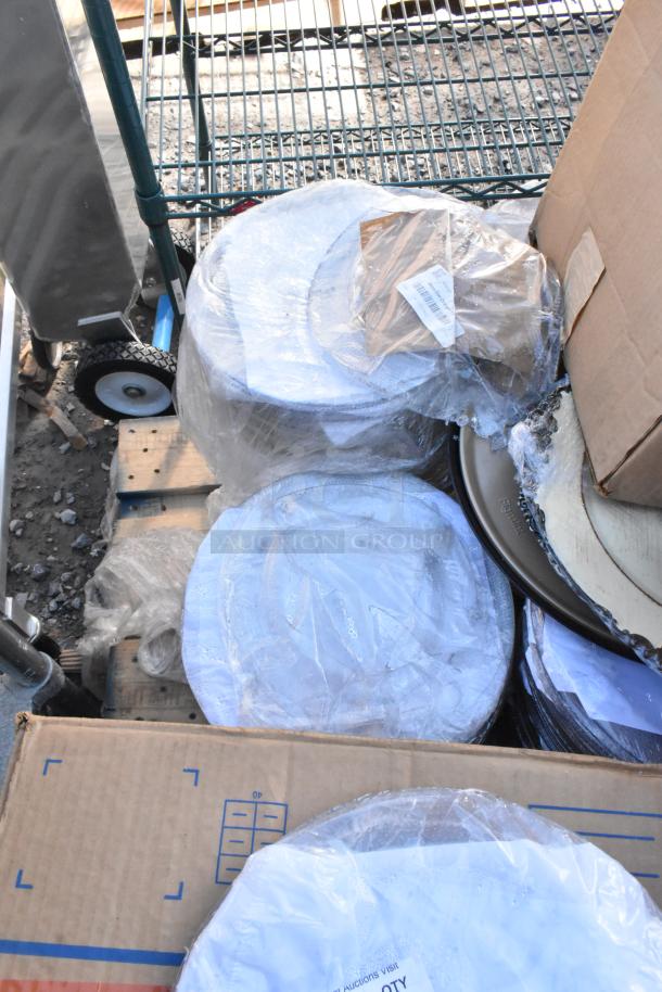 Pallet with mini cooler, stacks of CTR64BD disposable bowls, and napkins, wrapped in packaging, on a warehouse floor.