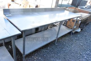 Stainless steel table with metal under shelf and back splash, in good condition. Ideal for commercial use.