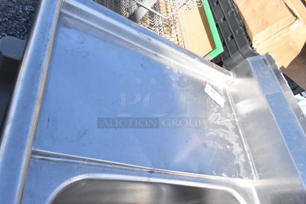 Stainless steel 2 bay sink with dual drain boards, visible faucet holes, lightly used condition, includes handles.