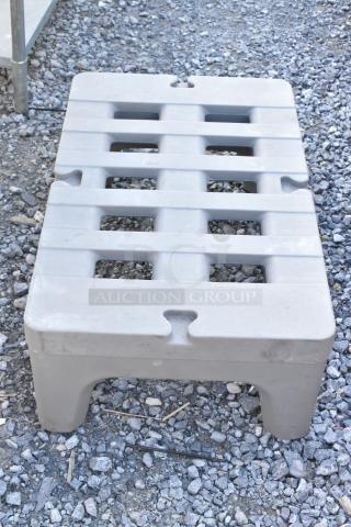 Two Metro gray poly dunnage racks, sturdy, stackable, used for storage, with slatted surface, in good condition.