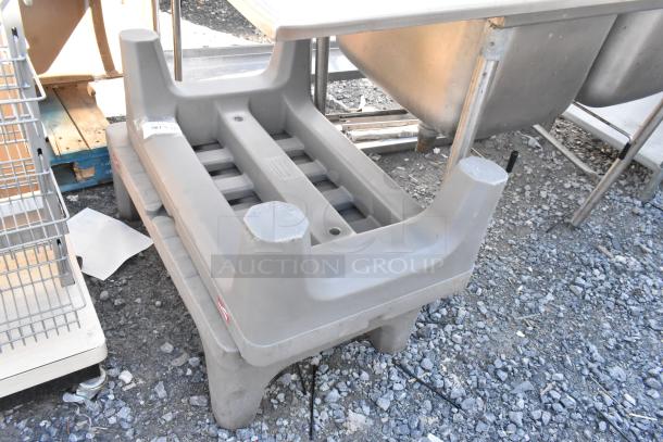 Two Metro gray poly dunnage racks, sturdy, stackable, for heavy-duty storage. Slight wear visible on surfaces.