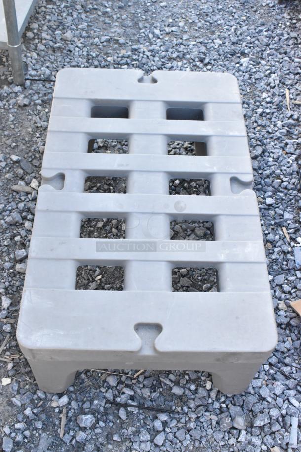 Two gray Metro poly dunnage racks, slotted design, durable plastic, excellent condition, ideal for storage solutions.