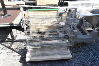 Metal display rack with multiple wire shelves on casters, suitable for retail, in good condition.