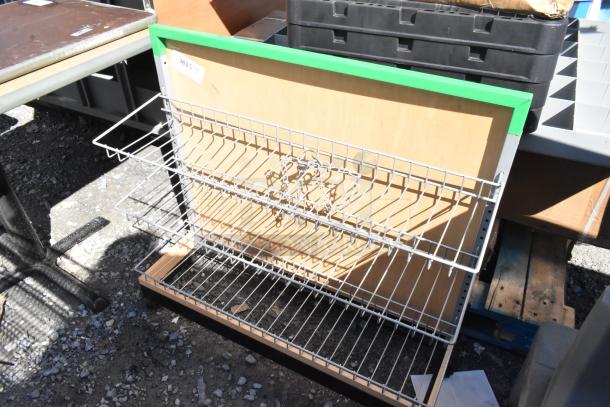 Display rack on casters with wire shelves, wood backing, and green trim. Used condition, label reads "363 3/4".