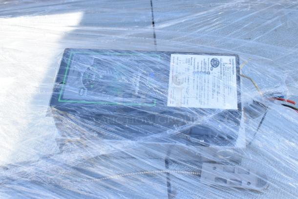 Norlake Self Contained Walk-In Box with Norlake Condenser, wrapped in plastic, 208-230V, 1 Phase visible on label.