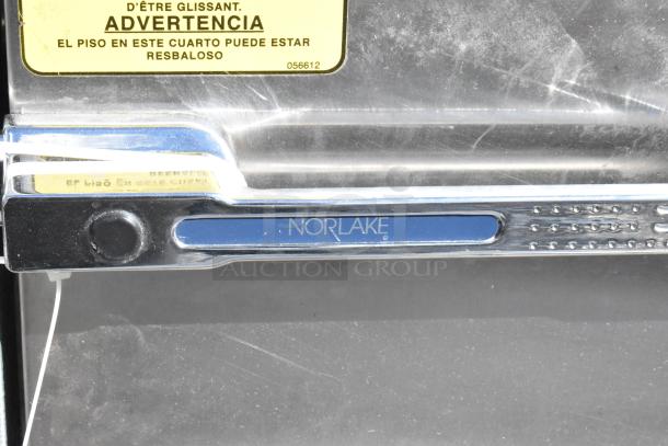Norlake self-contained walk-in box with condenser, chrome handle, warning label, 208-230V, 1 phase, scratched surface.