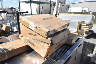 Boxes labeled "600MS2424" and "Microwave Shelf" Regency items in warehouse. Boxes are scratch and dented.