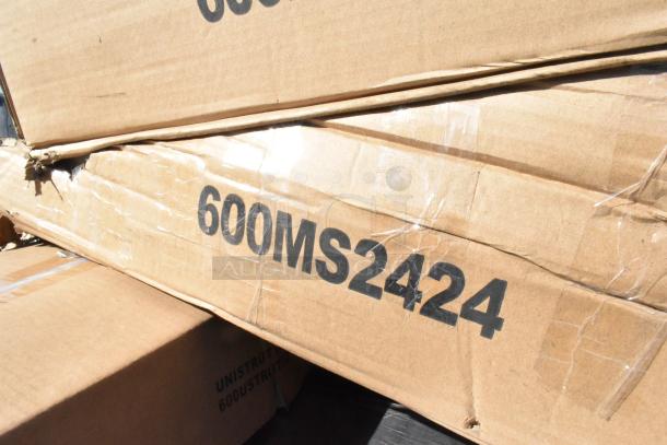 Cardboard box labeled "600MS2424" with visible dents, containing Regency 24" x 24" stainless steel microwave shelves.
