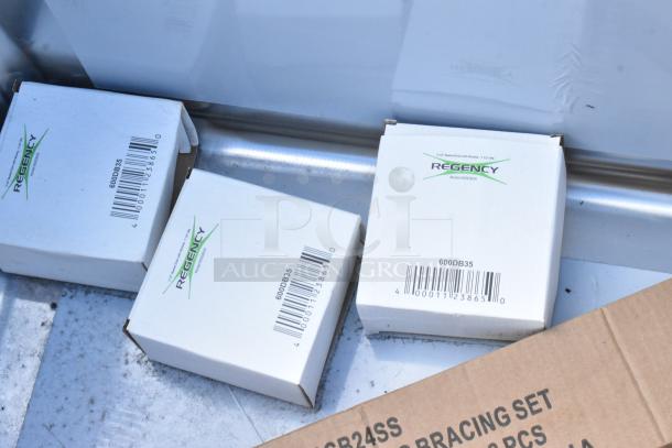 Brand new Regency 600S32424 stainless steel 3 bay sink, scratch and dent condition, with boxed components visible.