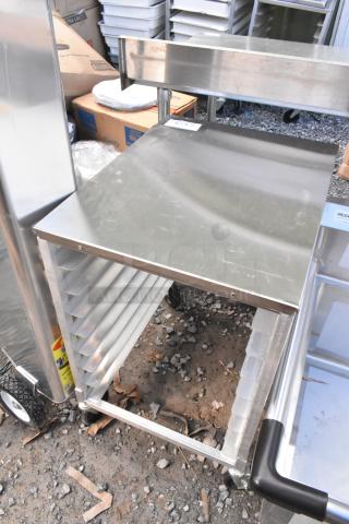 Brand new metal pan transport rack, minor scratches, on commercial casters. Ideal for kitchens, sturdy construction.