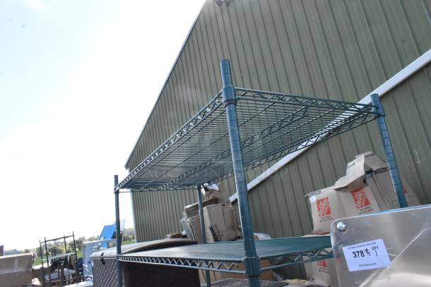 Green finish 5-tier wire shelving unit outdoors, sturdy, with visible auction tag. Buyer must dismantle; freight charges apply.