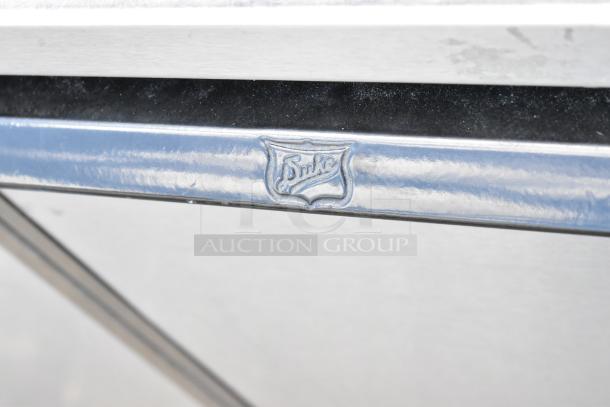 Duke Stainless Steel Commercial 2 Door Work Top Counter, featuring embossed logo, pristine condition.