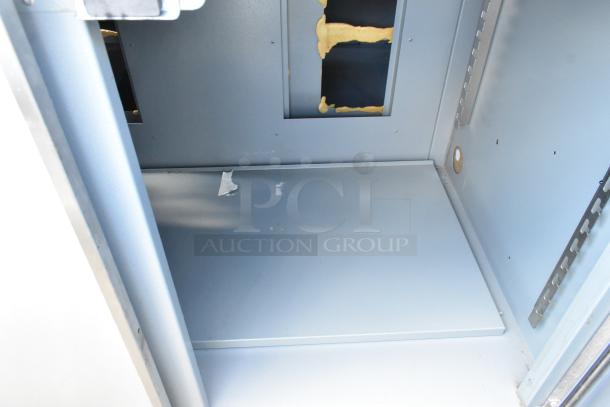 Duke stainless steel worktop counter interior, features two doors. Shows slight wear, with visible tape residue inside.