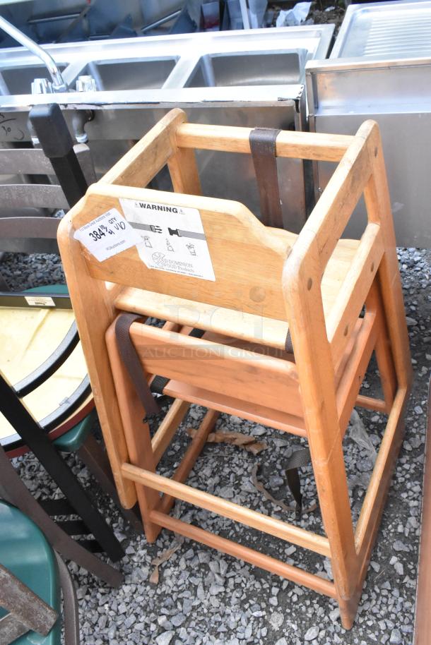 Wooden high chair with safety strap, visible warning label, Old Dominion Wood Products, included in auction of 10 items.