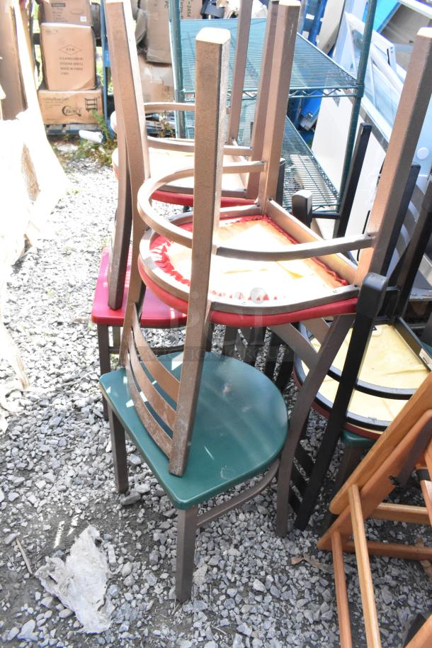 10 mixed chairs including wooden high chairs and brown metal dining chairs, stacked. Various conditions, outdoor setting.