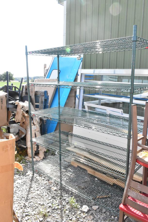 Green finish 5-tier wire shelving unit, outdoor setting, durable metal, slight wear, buyer must dismantle, freight applicable.