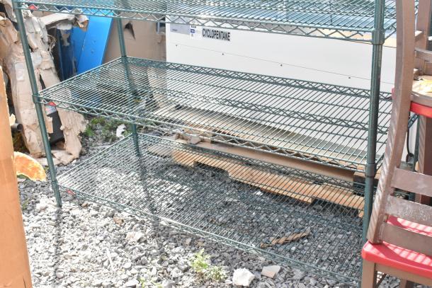 Green finish 5-tier wire shelving unit outdoors. Buyer must dismantle. Consider freight charges.