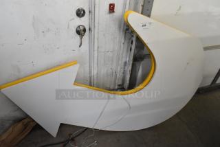 White subway arrow sign with yellow trim, in good condition. Auction label reading "For Sale: Great Auction Item, QTY 2".