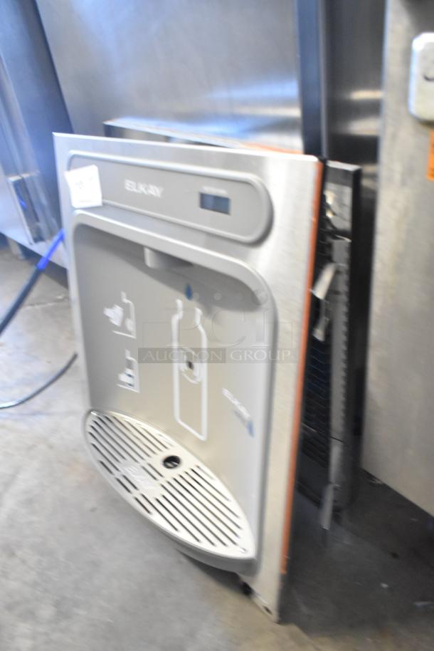 Brand new Elkay water fountain with bottle filler, scratch and dent condition, digital display, wall-mountable design.