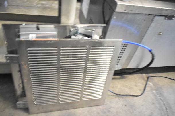 Brand new Elkay water fountain with bottle filler, showing minor scratches and dents. Metal front panel, visible blue tubing.