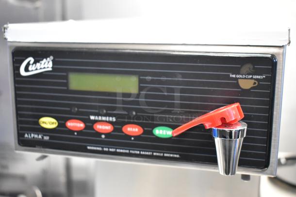 Curtis ALP3GTR12A000 stainless steel coffee brewer control panel with on/off, brew, and warmer buttons.