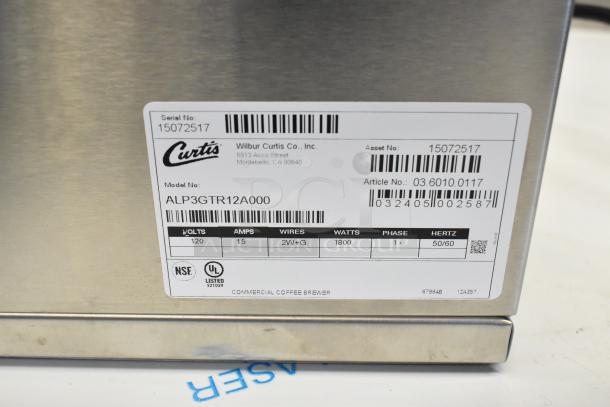 Curtis ALP3GTR12A000 stainless steel 12-cup coffee brewer, 3 warmers on right. NSF, UL listed. 120V, 1800W, new with scratch/dent.