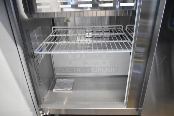 Brand new Avantco 178APT48MHG stainless steel prep table interior; visible wire shelves, commercial-grade, 115V.