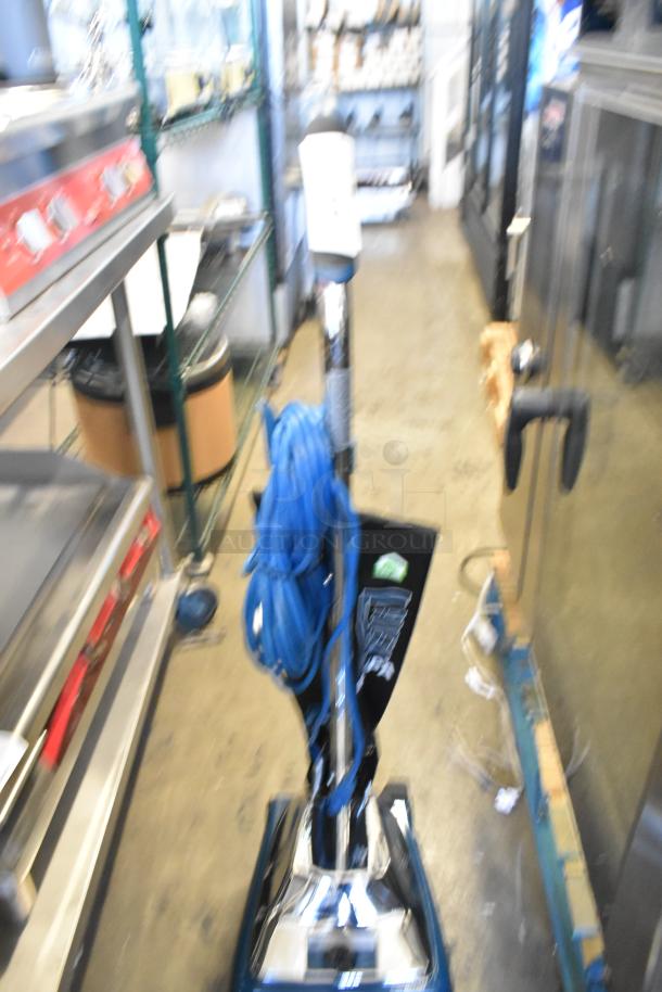 Brand new Lavex 457LAVHEPA12 upright vacuum cleaner with HEPA filtration, 12" width, 120V, slight cosmetic scratches.