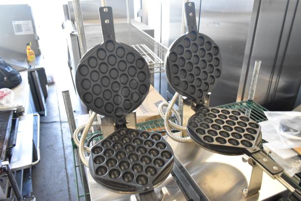 2 new Carnival King 382BWM30 bubble waffle makers, non-stick, with timer, 120V, scratch and dent condition.