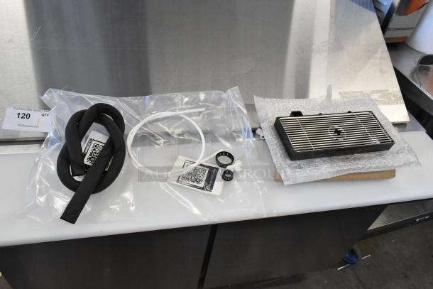 Brand new scratch and dent drip tray with protective packaging. Includes installation accessories in labeled bags.