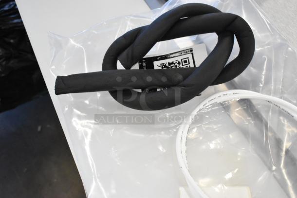 Brand new drip tray in packaging with scratch and dent condition. Features black coiled tubing and white ring. Tags included.