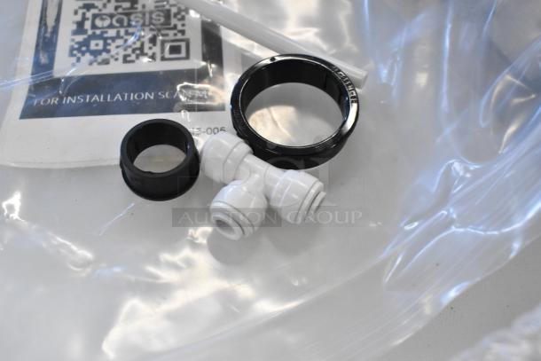Brand new scratch and dent drip tray components, including black and white fittings, packaged with installation QR code.