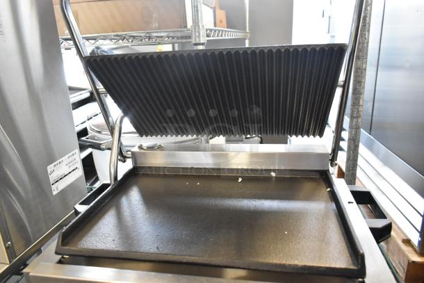 BRAND NEW Avantco 177PG200GS stainless steel commercial panini grill with grooved top, smooth bottom plates. Cooking surface: 13 3/8" x 8 3/4". 120V.