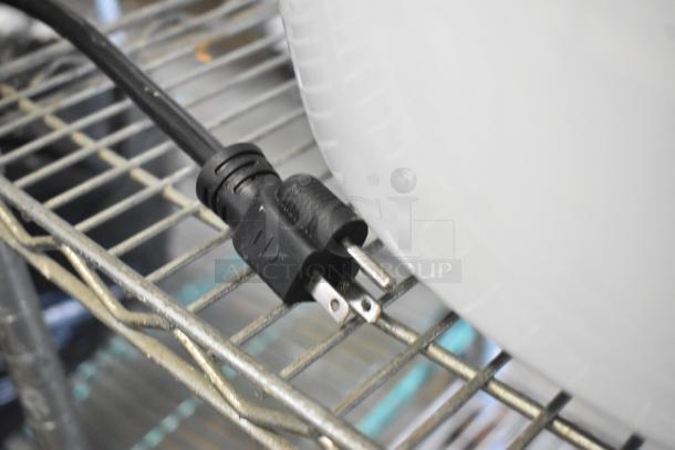 Close-up of the power cord for a new Avantco 177PG200GS Panini Grill on a metal shelf.