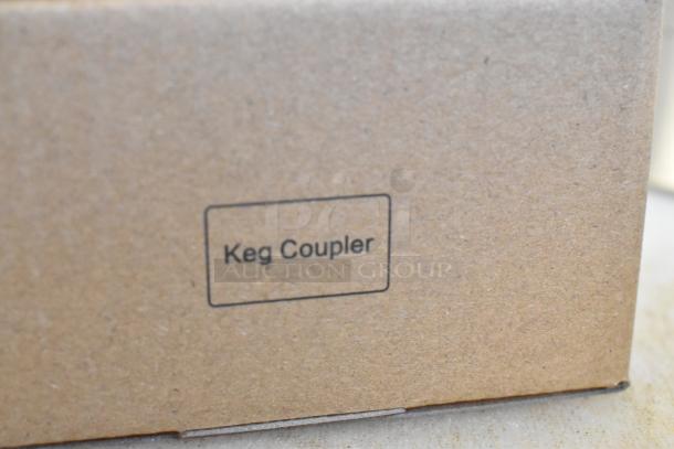Cardboard box labeled "Keg Coupler," part of a lot with Avantco 178TOWERDBL 2 Tap Tower and couplers, new scratch and dent condition.