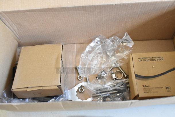 Box containing scratch and dent Avantco 178TOWERDBL 2 Tap Tower, 3" Column, keg couplers, and parts with packaging.