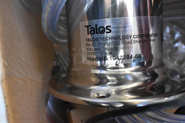 Stainless steel part from Talos with model number 1042204-00. Includes tubing and visible scratch and dent condition.