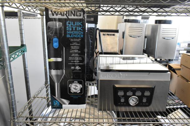 Waring Quick Stik immersion blender in box and Galaxy chamber vacuum packing machine. New condition, on metal shelf.