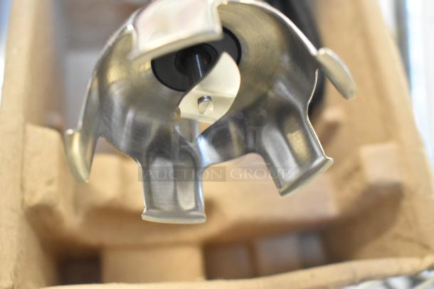 Close-up of a stainless steel blade on a Waring WSB35 Quick Stik immersion blender in packaging.