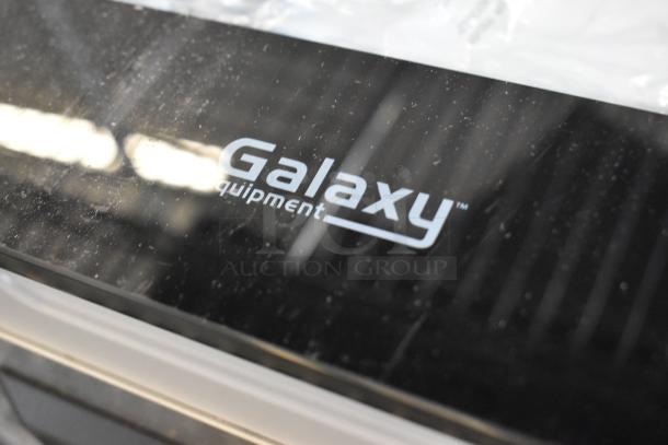 "Galaxy equipment logo on a black surface, part of Galaxy 177GVMC10P Chamber Vacuum Packing Machine, new condition."