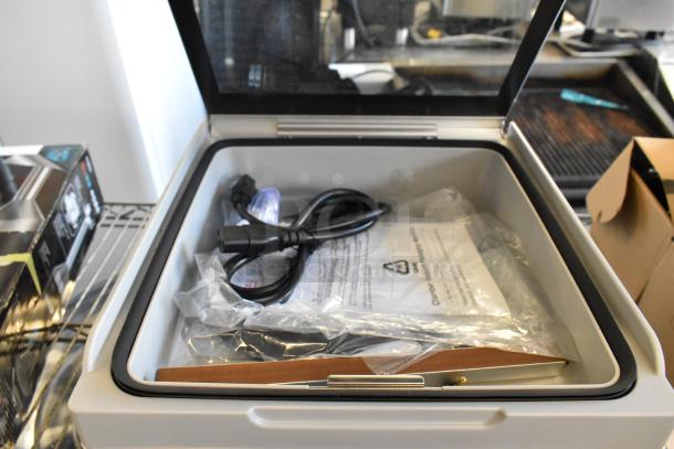 Galaxy 177GVMC10P Chamber Vacuum Packing Machine in open box, includes manuals and cables, brand new condition.