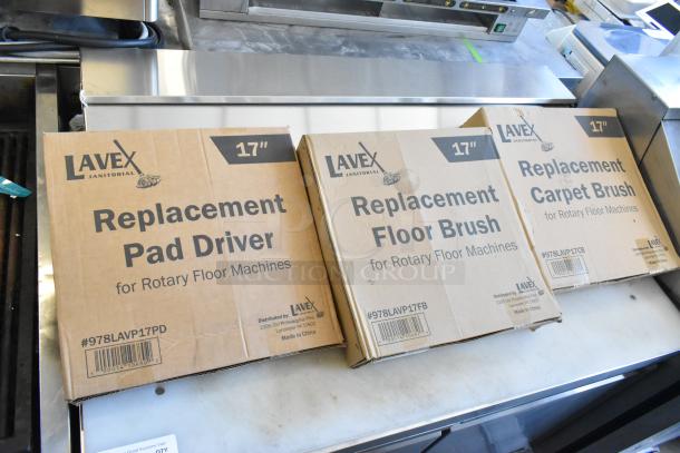 Three Lavex boxes for 17" rotary floor machines: Pad Driver, Floor Brush, Carpet Brush. New condition, model numbers visible.