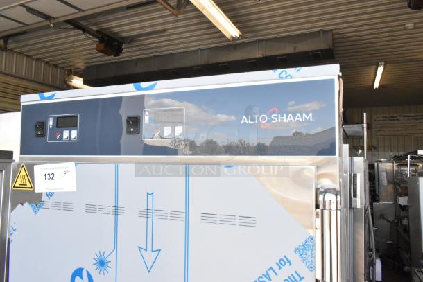 Brand new Alto Shaam stainless steel heated holding cabinet, scratch and dent, two half-size doors, on commercial casters.