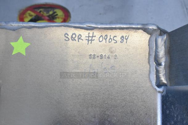 Stainless steel Shortening Shuttle SS-914-B, engraved with "SQR# 096584" and "1/31/25," includes a green star sticker.